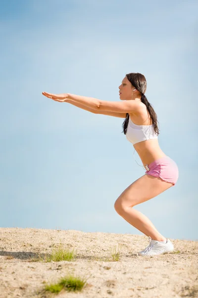 Letní sport fit žena táhnoucí se na pláži — Stock fotografie