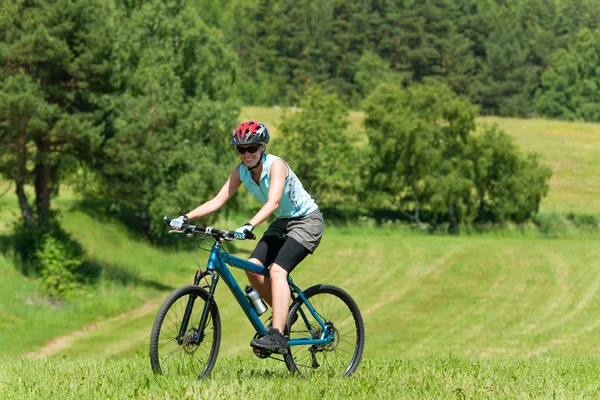 Горные девушки на велосипеде в гору солнечные луга — стоковое фото