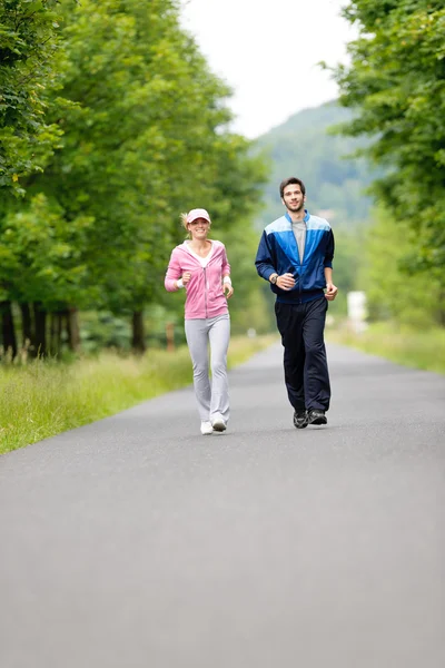 Τζόκινγκ sportive νεαρό ζευγάρι τρέχει πάρκο δρόμο — Φωτογραφία Αρχείου