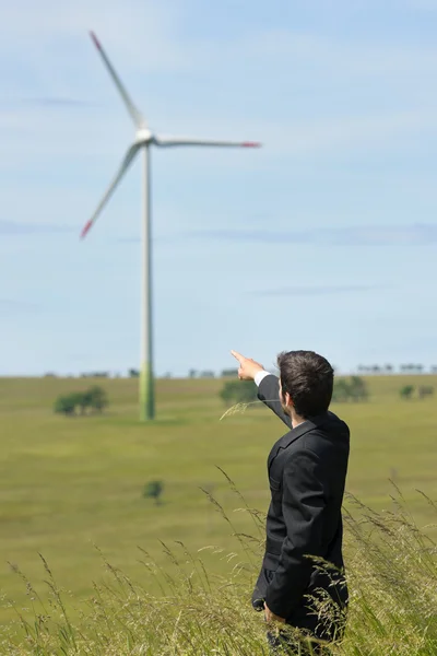 Green energy - Young businessman point windmill — Stock Photo, Image
