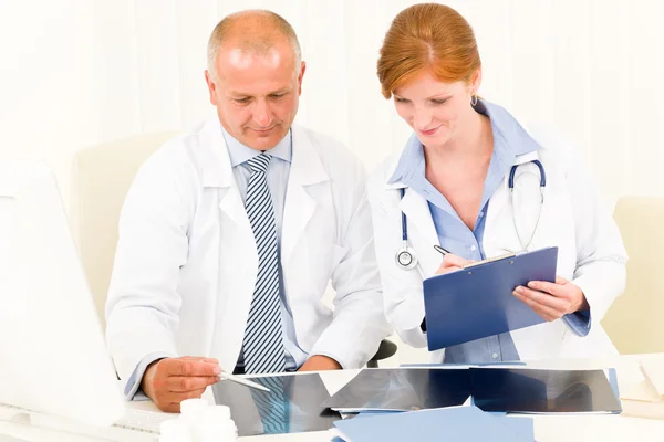 Medical doctor team look point at x-ray Stock Image