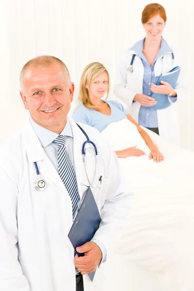 Ärzte mit liegendem Krankenhausbett Stockbild