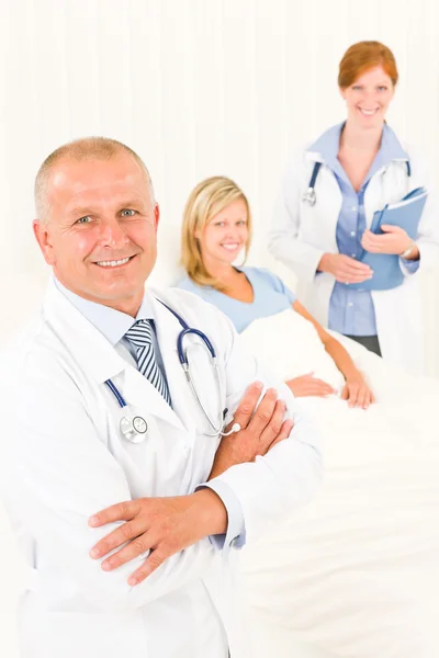 Medical doctors with hospital patient lying bed Royalty Free Stock Images