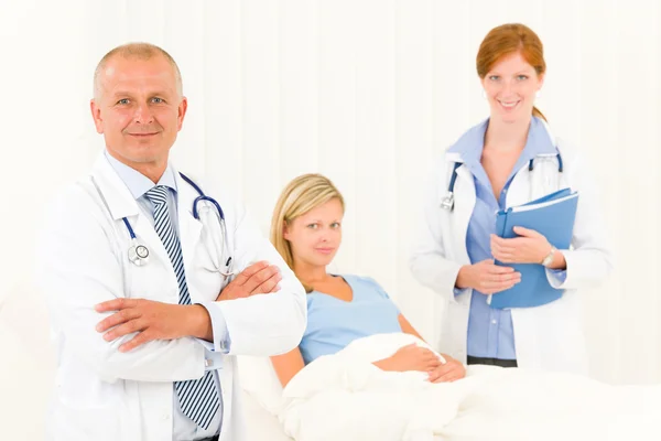Medical doctors with hospital patient lying bed Stock Picture
