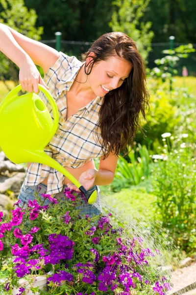 Gardening smiling woman watering can violet flower — Stock Photo, Image