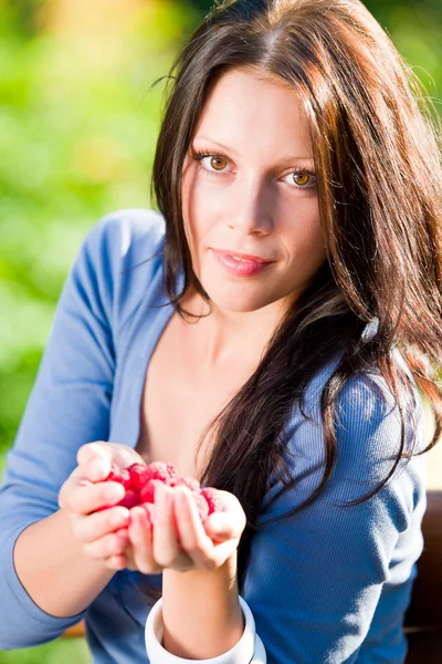 Fresh raspberries hold hand cheerful smiling woman — Stock Photo, Image