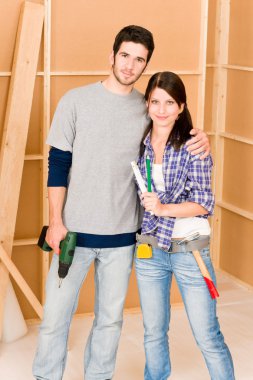 Home improvement young couple with repair tools clipart