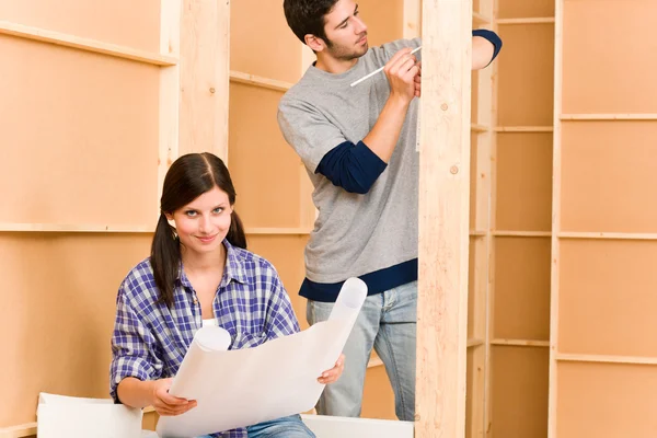 Home improvement young couple with blueprints — Stock Photo, Image