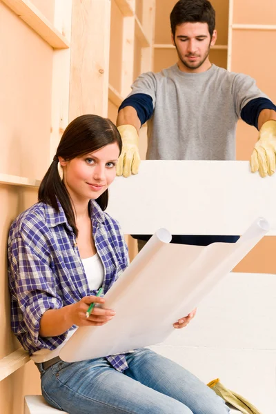 Home improvement young couple with blueprints — Stock Photo, Image