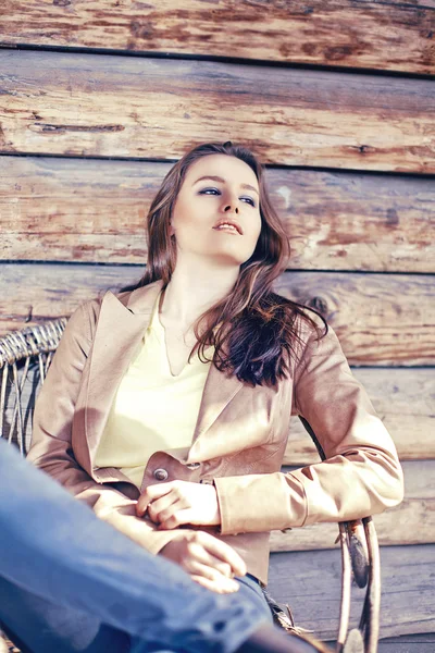 Young beautiful brunette woman sit in arm chair — Stock Photo, Image
