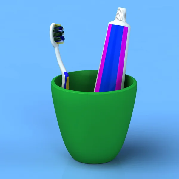 緑のカップの歯ブラシとゲルの歯磨き粉 — ストック写真