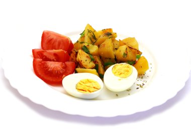 Eggs laying next to potatoes and tomatoes clipart