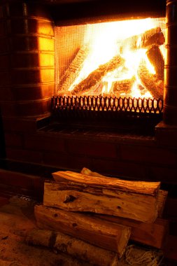 Foto of warm fireplace at late evening clipart