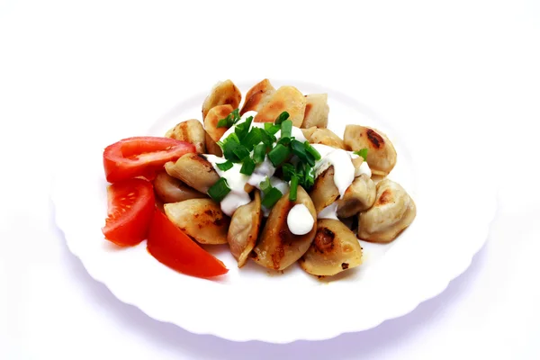 stock image Foto of dumplings and tomato on plate