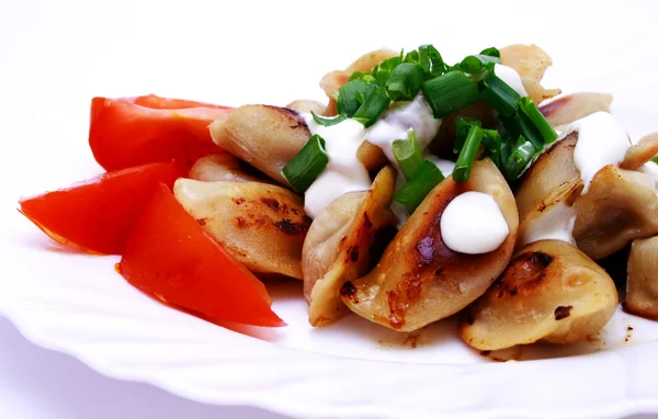 Stock image Foto of dumplings and tomato on plate