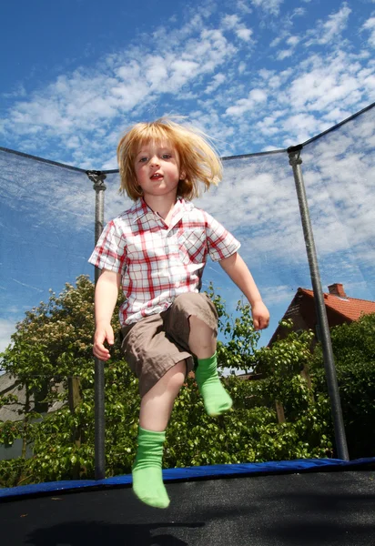 Child jumping trampoline — Stock Photo, Image