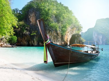 Long boat at island in Thailand clipart