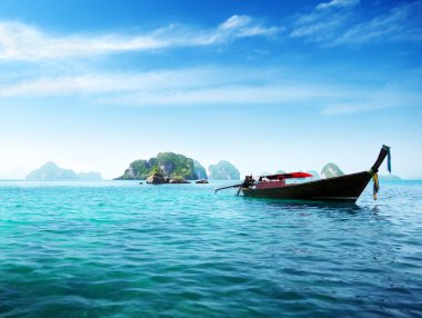 Boat and islands in andaman sea Thailand clipart