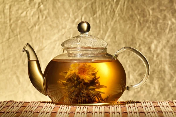 Glass teapot and a cup of green tea on a black background — Stock Photo, Image