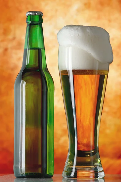 Bottle glass of beer on a yellow background — Stock Photo, Image