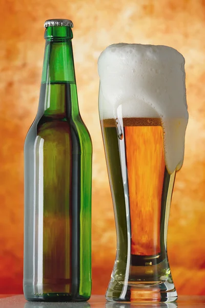 Bottle glass of beer on a yellow background — Stock Photo, Image