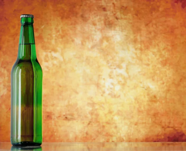 Beer bottle on sacking with copy-space — Stock Photo, Image
