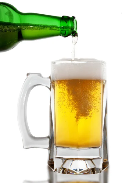 Beer is pouring into glass on white background — Stock Photo, Image