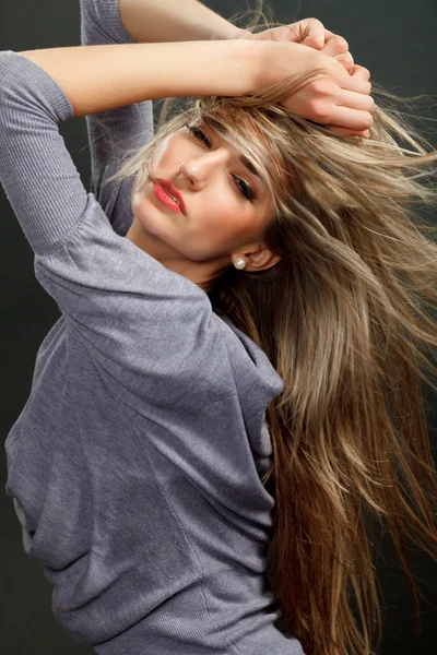 Portrait of a beautiful girl with flying blond hair — Stock Photo, Image