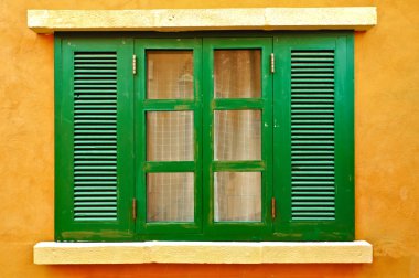 Green window on yellow wall clipart