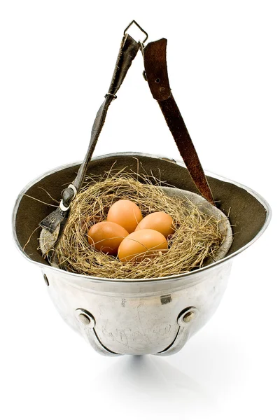 Nest with eggs in old army helmet — Stock Photo, Image