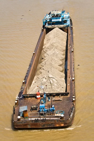 stock image Riverboat barge with sand on green river