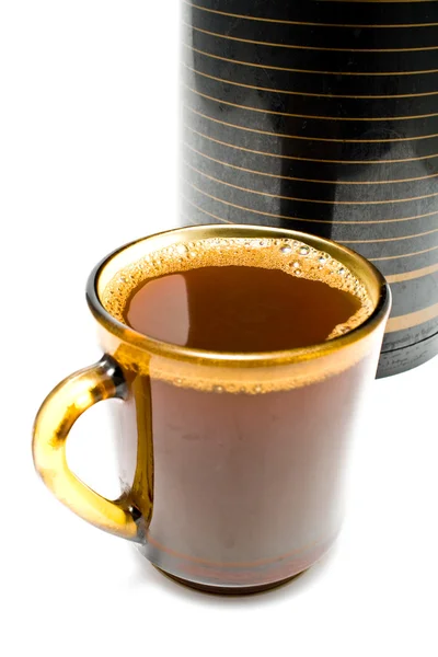 Cup of coffee in front of thermos — Stock Photo, Image