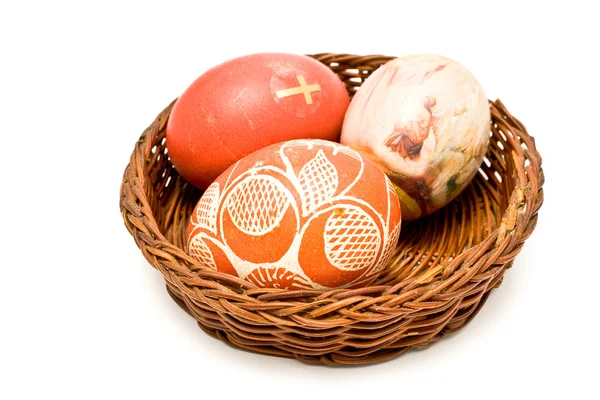 stock image Painted easter eggs in brown basket