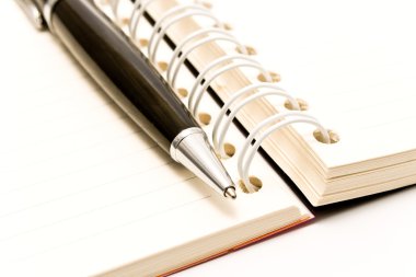 Close-up of pen and spiral agenda clipart