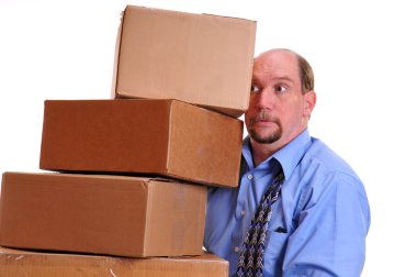 Man carrying heavy boxes hoping not to drop them clipart