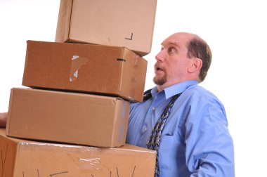 Man carrying heavy boxes hoping not to drop them. clipart