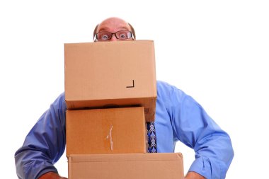 Man carrying several heavy boxes. clipart