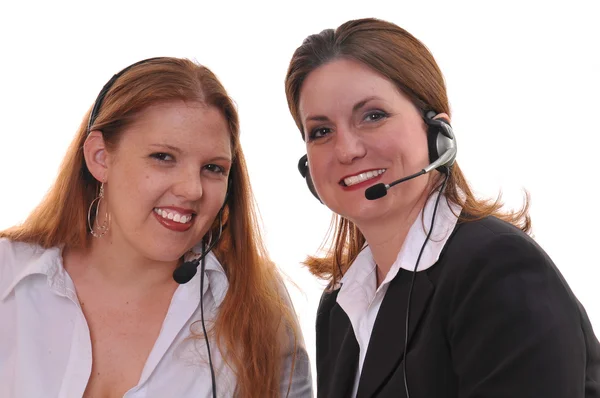 Dwie kobiety biznesu ze słuchawkami — Zdjęcie stockowe