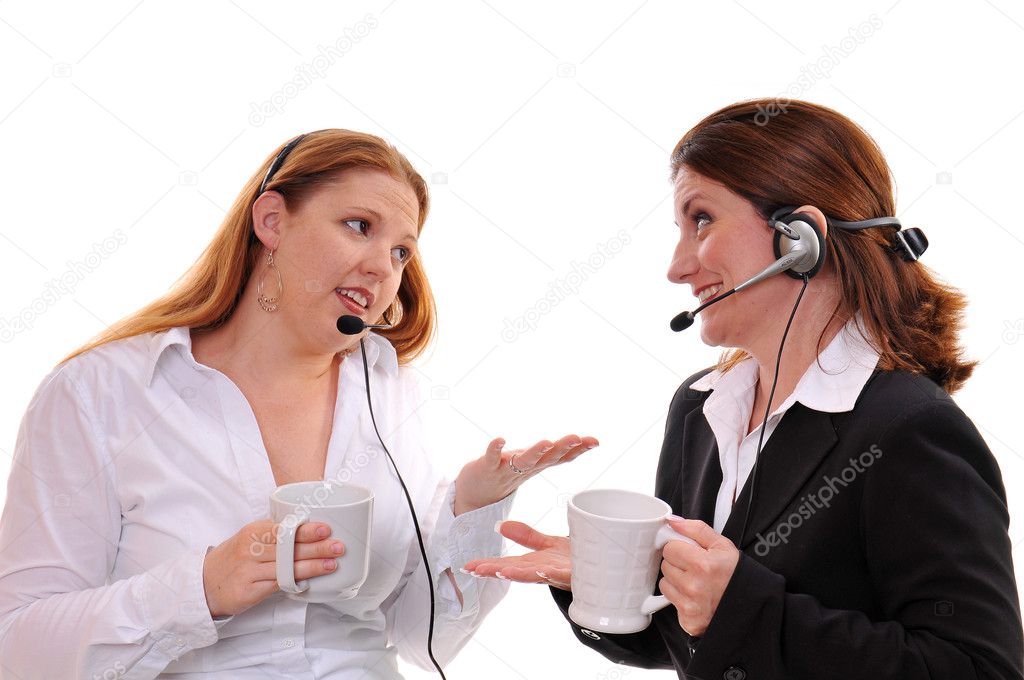 Two business women wearing headsets