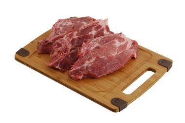 Three raw steaks on bamboo cutting board clipart