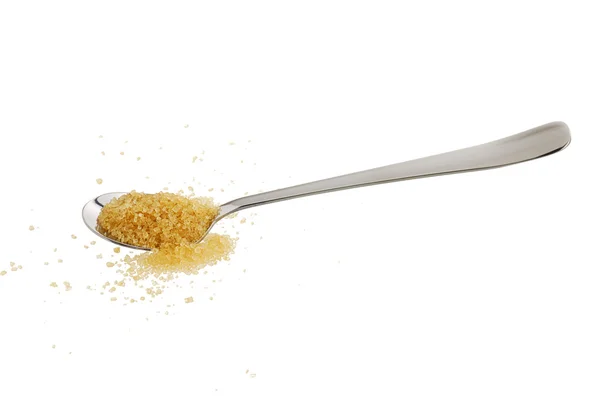 Dourado açúcar demerara derramado a partir de colher de chá — Fotografia de Stock