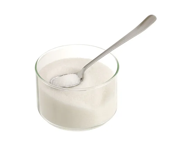 Azúcar blanco en tazón de vidrio con cucharadita — Foto de Stock