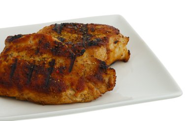 Grilled chops on square plate clipart