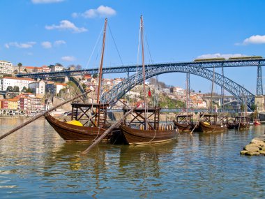 Old Porto and traditional boats with wine barrels clipart