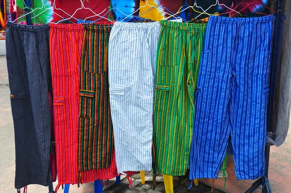 Brightly coloured handmade trousers in traditional market — Stock Photo, Image
