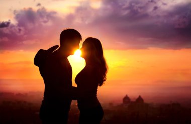 Couple silhouette at sunset clipart