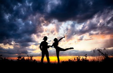 Couple silhouette at sunset clipart