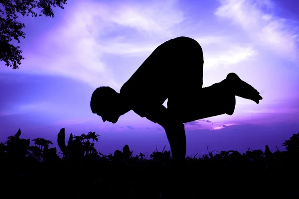 Yoga silhouette bakasana cane pose — стоковое фото