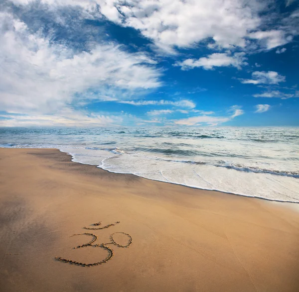 Om symbol on the beach — Stok fotoğraf