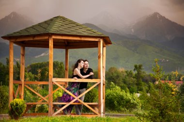 Young couple in mountains clipart